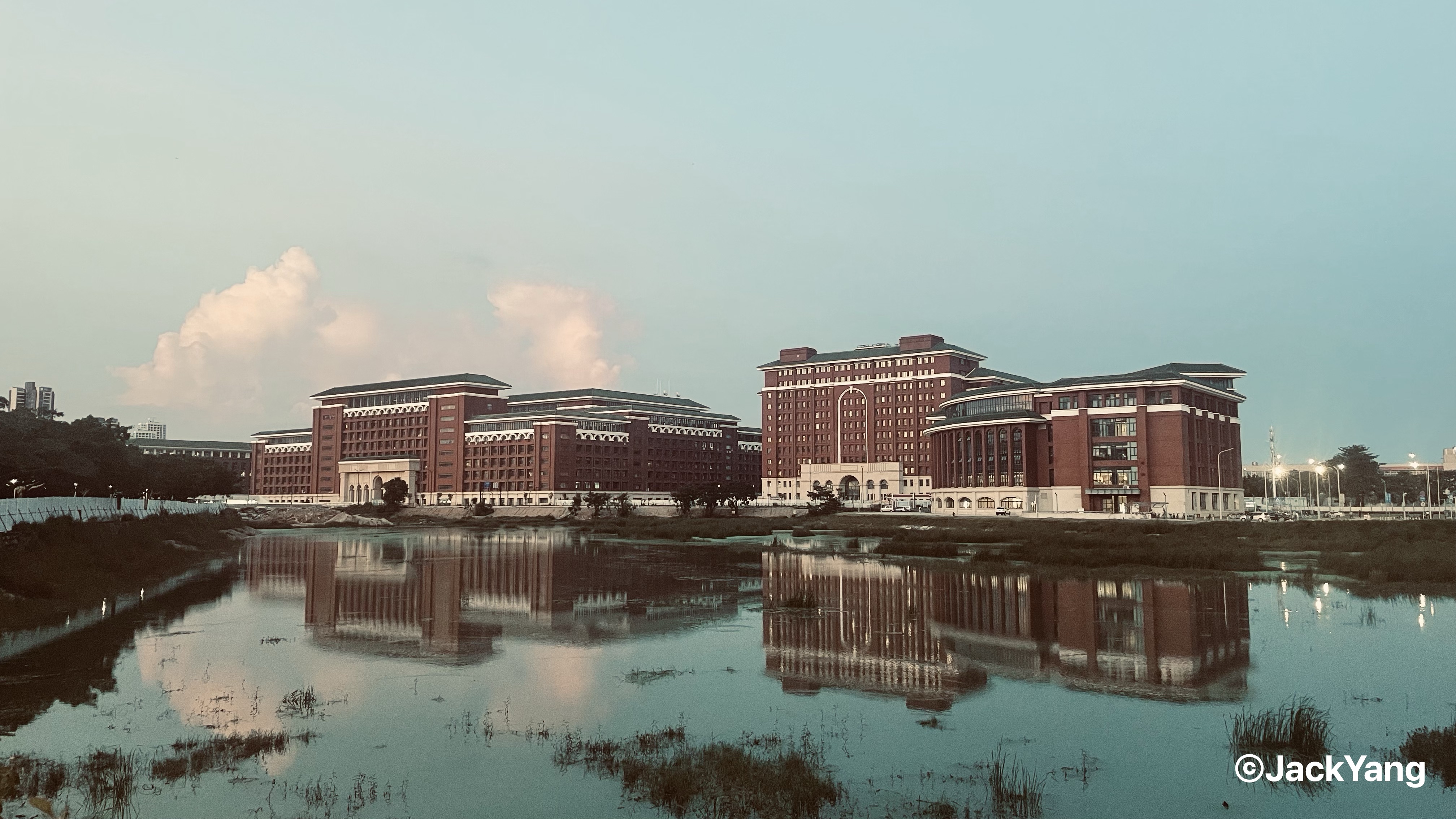 Sun Yat-sen University Zhuhai campus reflected in still water at dusk